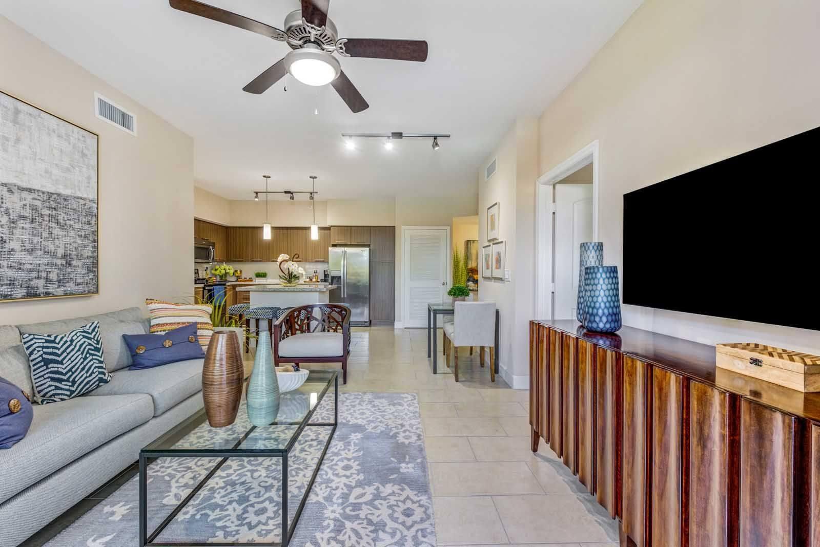 16808 Southwest 137th Avenue, Unit 922 Miami, FL 33177 - Photo 4 of 14 a living room with furniture and a flat screen tv