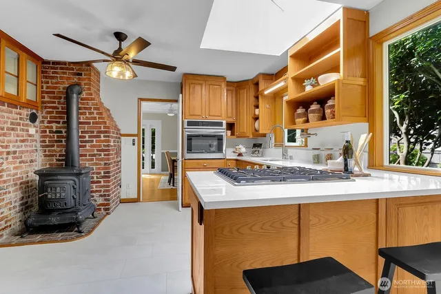 a kitchen with a sink appliances and a large window
