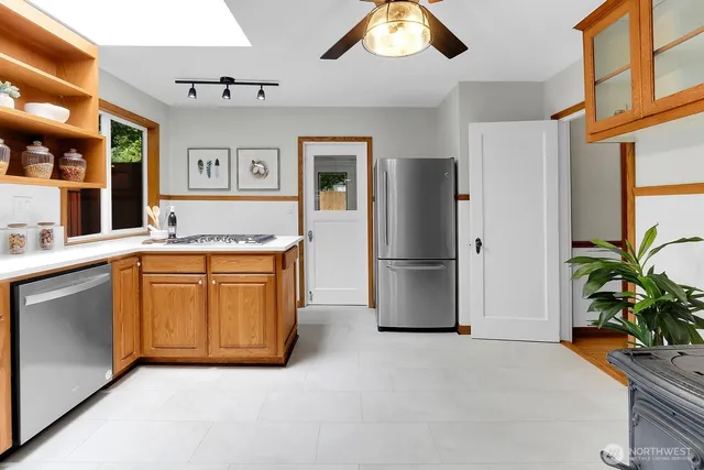 a kitchen with stainless steel appliances granite countertop a refrigerator and a stove