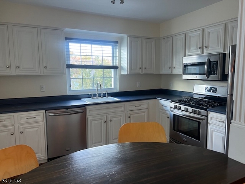 41 Rhea Run Newton, NJ 07860 - Photo 5 of 17 a kitchen with granite countertop wooden floors appliances and window