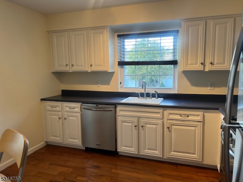 41 Rhea Run Newton, NJ 07860 - Photo 7 of 17 a kitchen with stainless steel appliances granite countertop a sink and cabinets with wooden floor