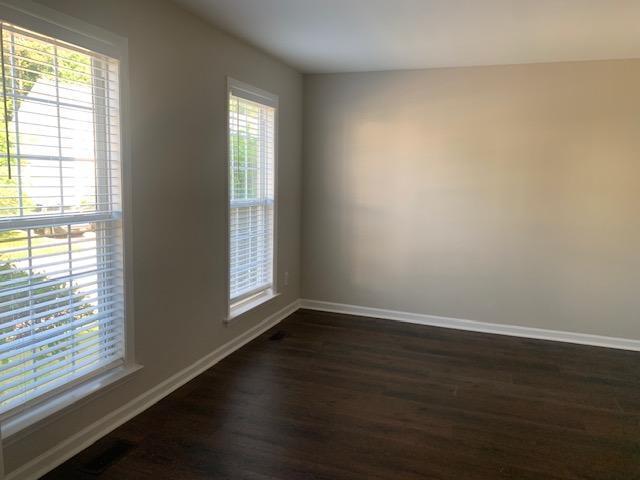 8320 Hobhouse Circle Raleigh, NC 27615 - Photo 2 of 16 an empty room with wooden floor and windows