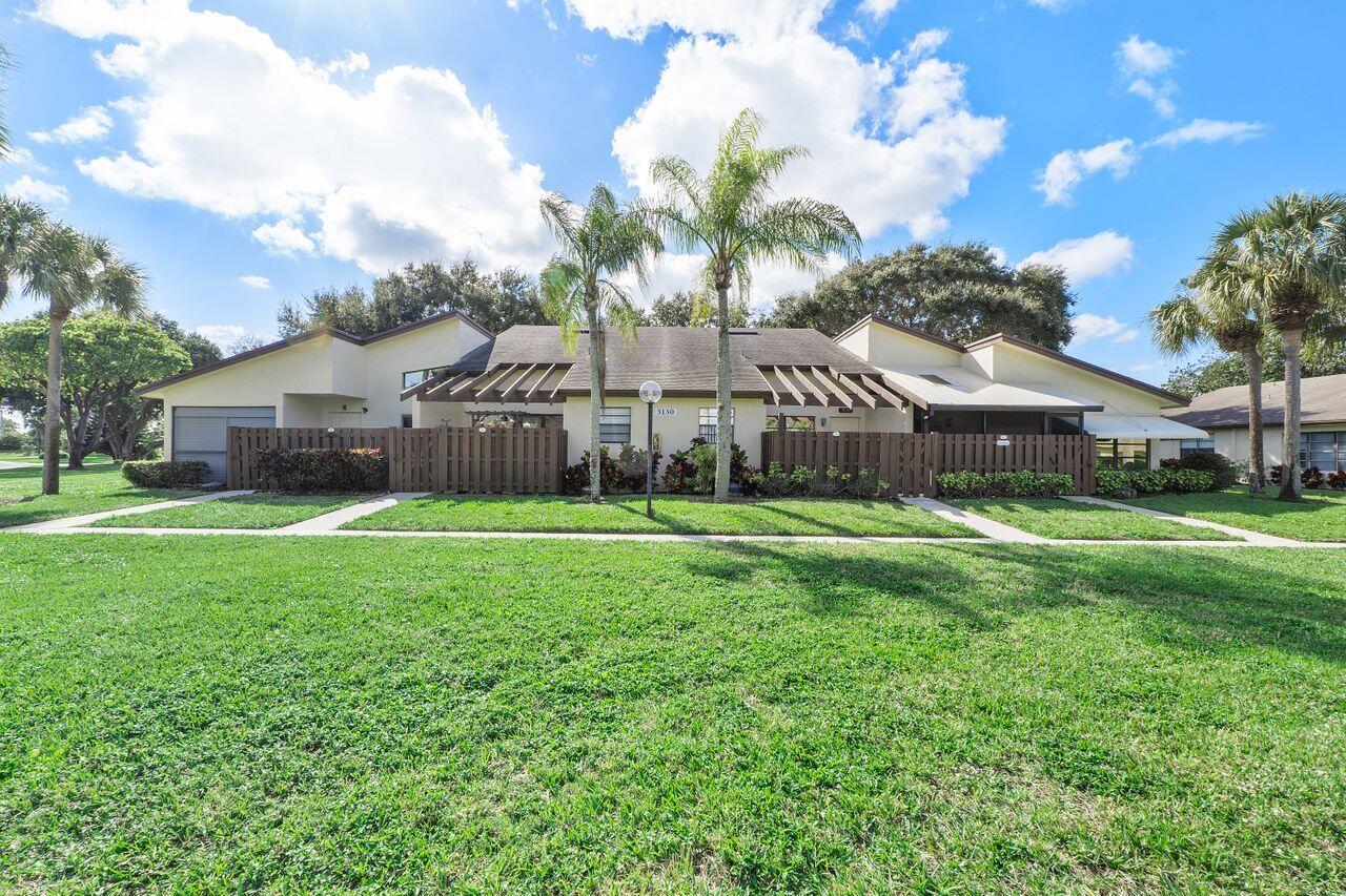5130 Nesting Way, Unit D Delray Beach, FL 33484 - Photo 2 of 41 a view of house with backyard