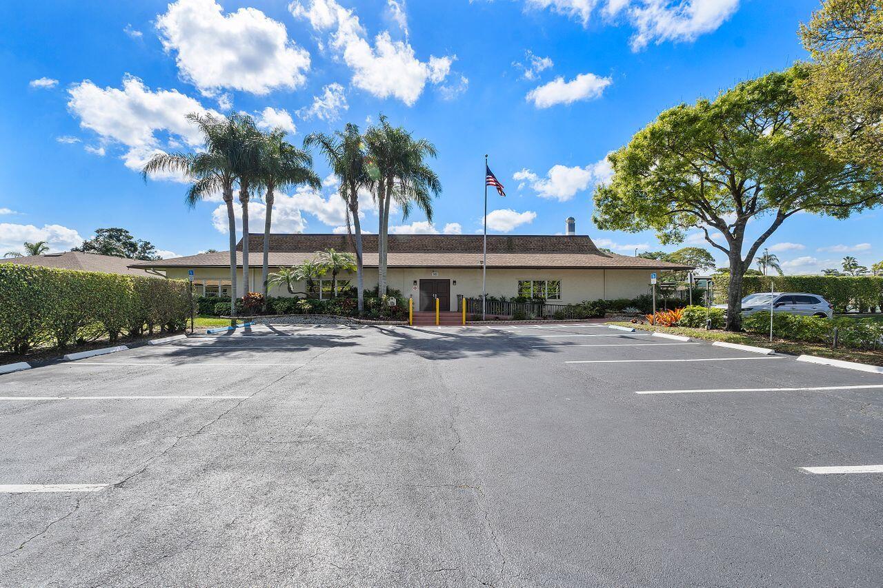5130 Nesting Way, Unit D Delray Beach, FL 33484 - Photo 27 of 41 a front view of a building with tree s