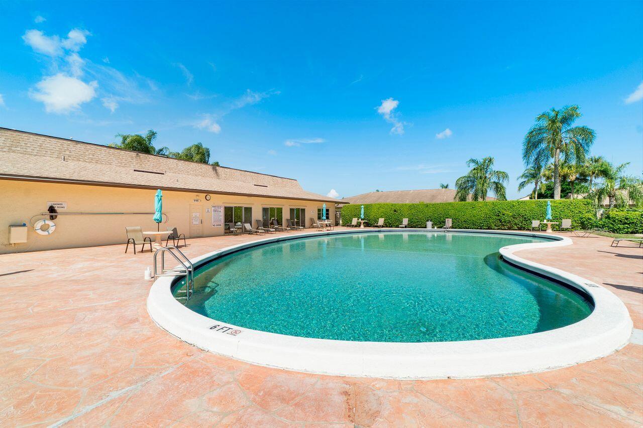 5130 Nesting Way, Unit D Delray Beach, FL 33484 - Photo 32 of 41 a view of a swimming pool with a yard