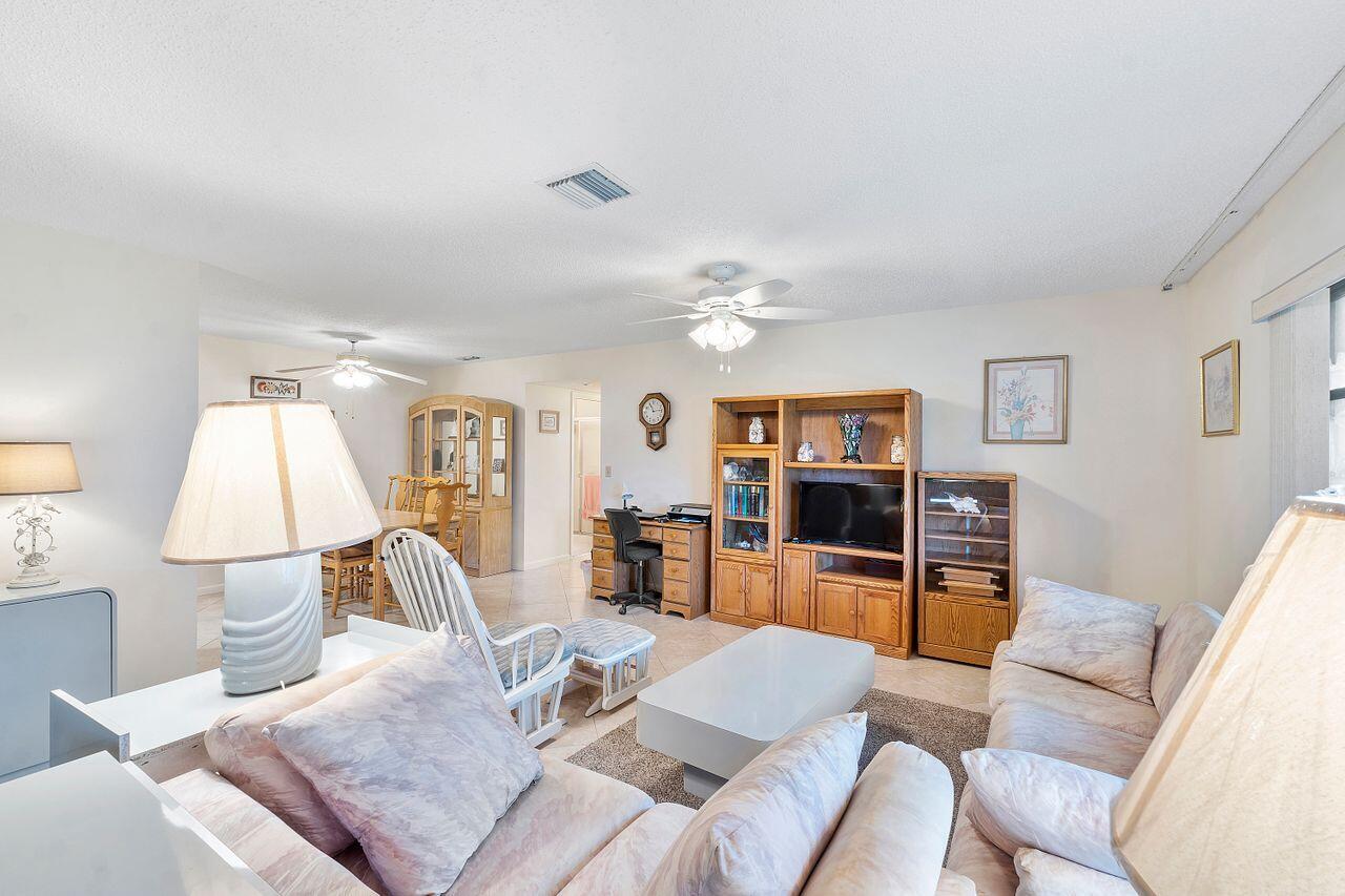 5130 Nesting Way, Unit D Delray Beach, FL 33484 - Photo 8 of 41 a living room with furniture and a flat screen tv