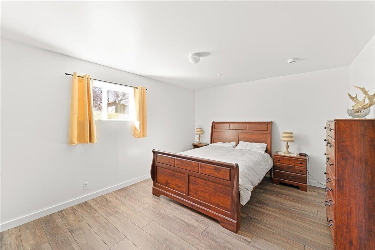 649 Pleasant Valley Road Merlin, OR 97532 - Photo 45 of 57 a bedroom with a bed and wooden floor