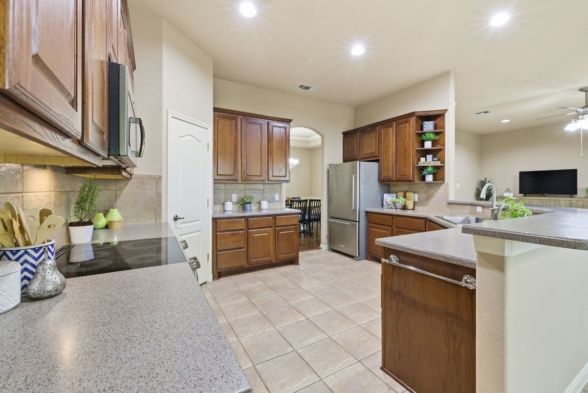 2291 Frontier Spring Branch, TX 78070 - Photo 12 of 39 a kitchen with stainless steel appliances kitchen island granite countertop a refrigerator a stove and a sink with cabinets