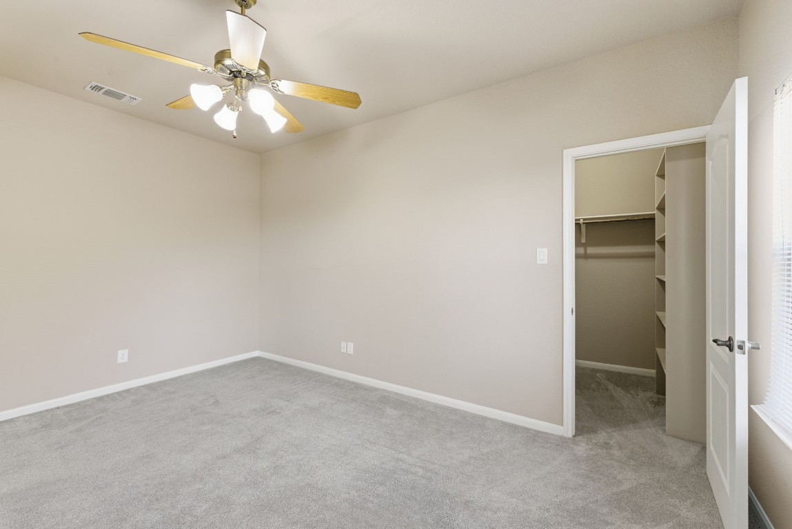 2291 Frontier Spring Branch, TX 78070 - Photo 21 of 39 an empty room with a chandelier fan and kitchen view