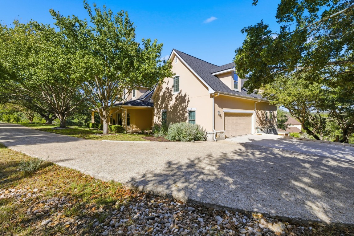 2291 Frontier Spring Branch, TX 78070 - Photo 36 of 39 a front view of a house with a yard and garage