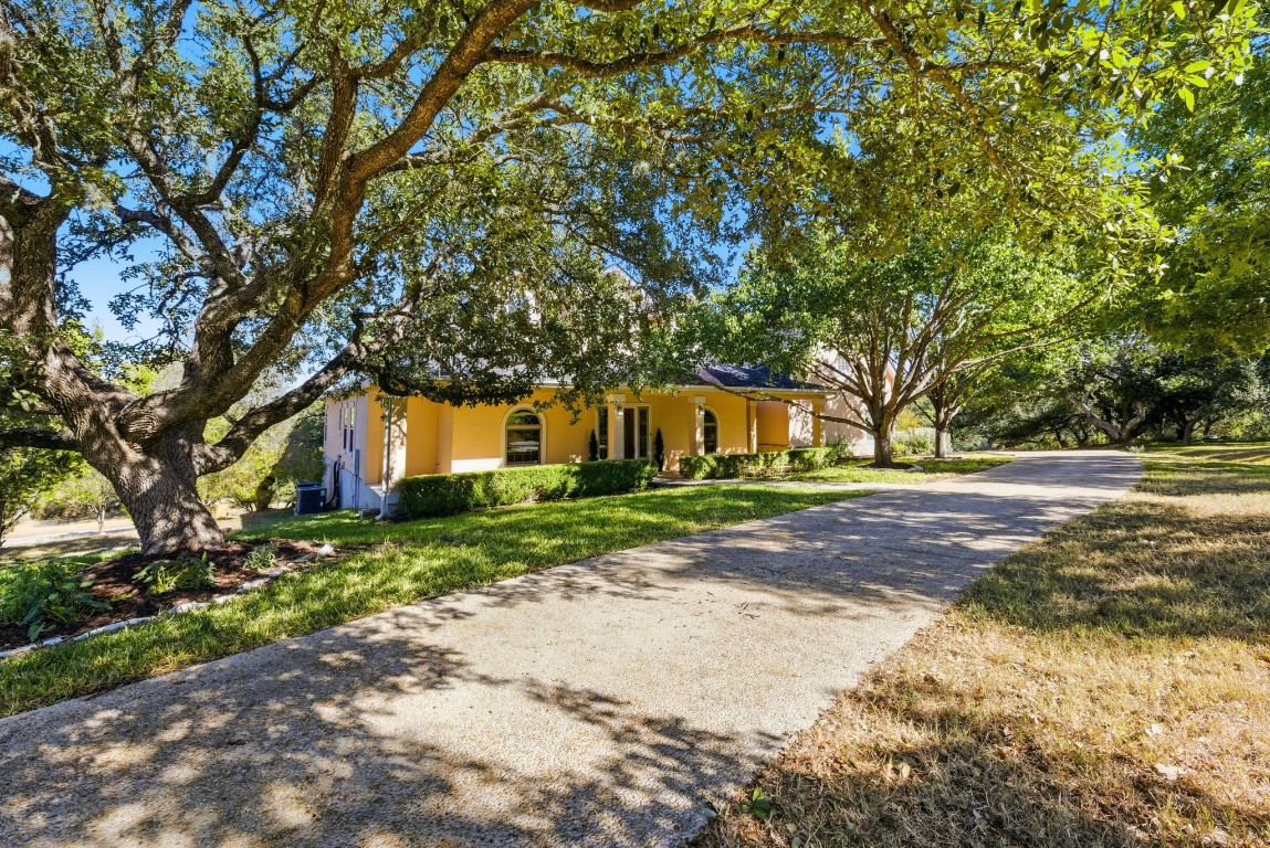 2291 Frontier Spring Branch, TX 78070 - Photo 37 of 39 a front view of a house with a yard and garage
