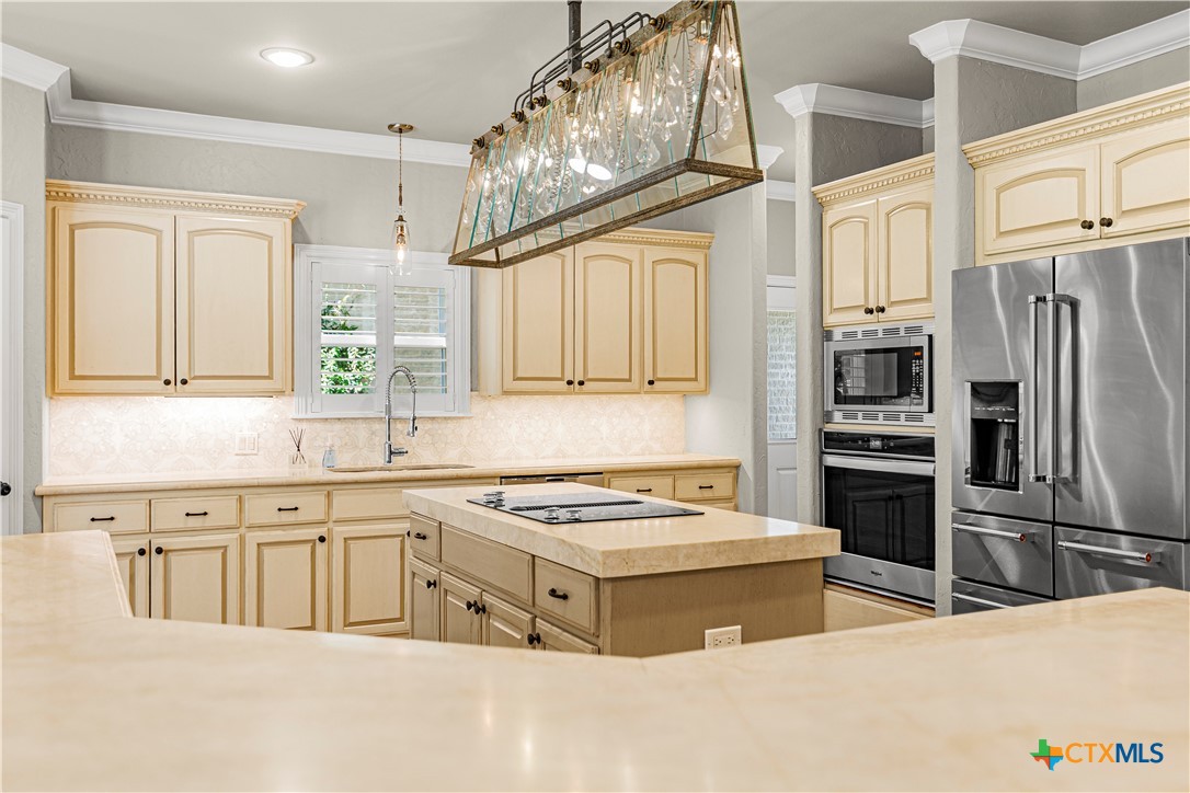 313 Treasure Oaks Road Inez, TX 77968 - Photo 12 of 47 a kitchen with stainless steel appliances a refrigerator a stove a sink and a refrigerator