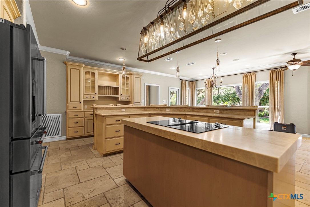 313 Treasure Oaks Road Inez, TX 77968 - Photo 13 of 47 a kitchen with a stove a sink and a refrigerator