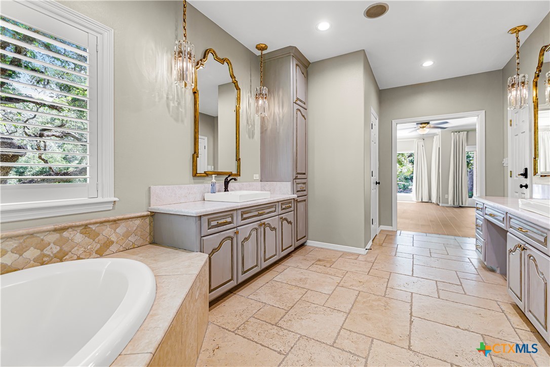 313 Treasure Oaks Road Inez, TX 77968 - Photo 17 of 47 a spacious bathroom with a double vanity sink a mirror and a bathtub