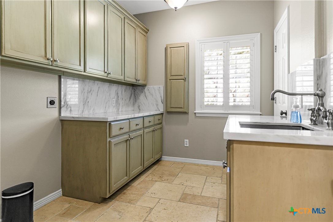 313 Treasure Oaks Road Inez, TX 77968 - Photo 19 of 47 a kitchen with stainless steel appliances granite countertop a sink and a refrigerator