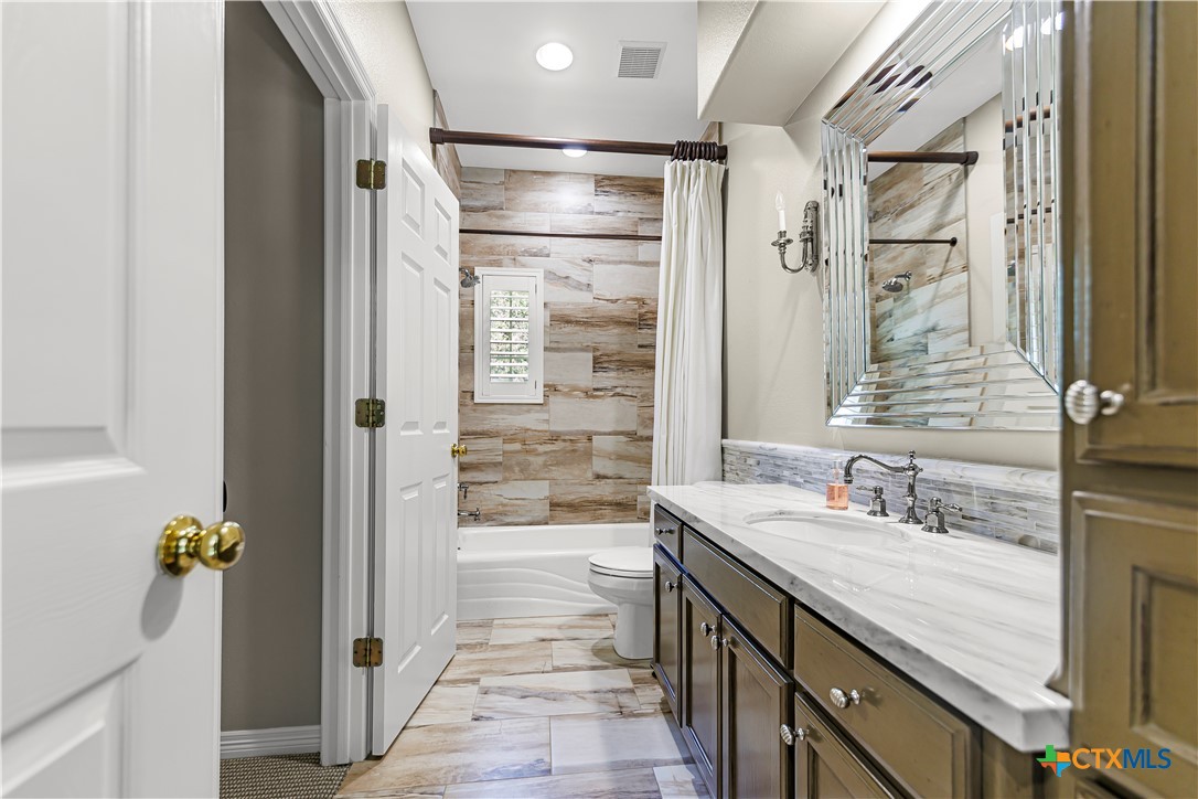 313 Treasure Oaks Road Inez, TX 77968 - Photo 26 of 47 a bathroom with a granite countertop shower mirror and a sink
