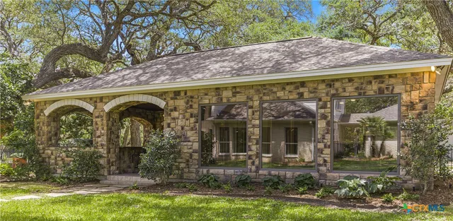 a front view of a house with garden