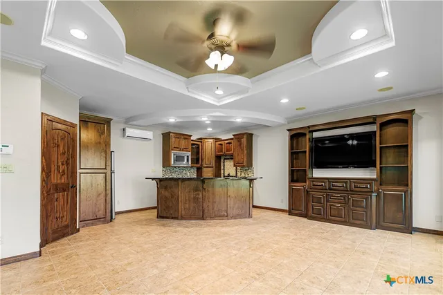 a view of kitchen with furniture and flat screen tv