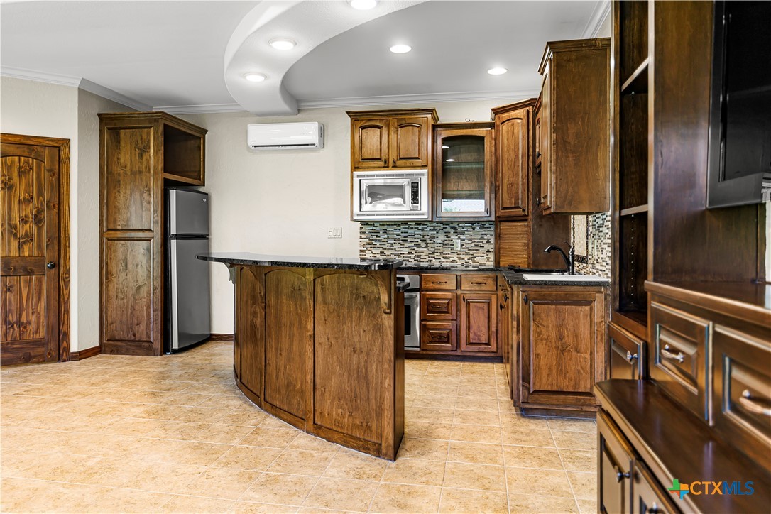 313 Treasure Oaks Road Inez, TX 77968 - Photo 31 of 47 a kitchen with stainless steel appliances granite countertop a refrigerator and a stove