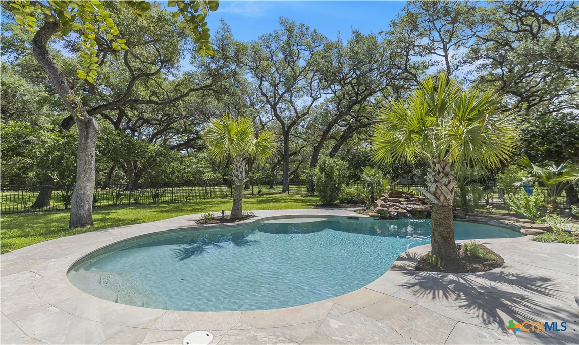 313 Treasure Oaks Road Inez, TX 77968 - Photo 36 of 47 a view of a swimming pool with a yard and trees