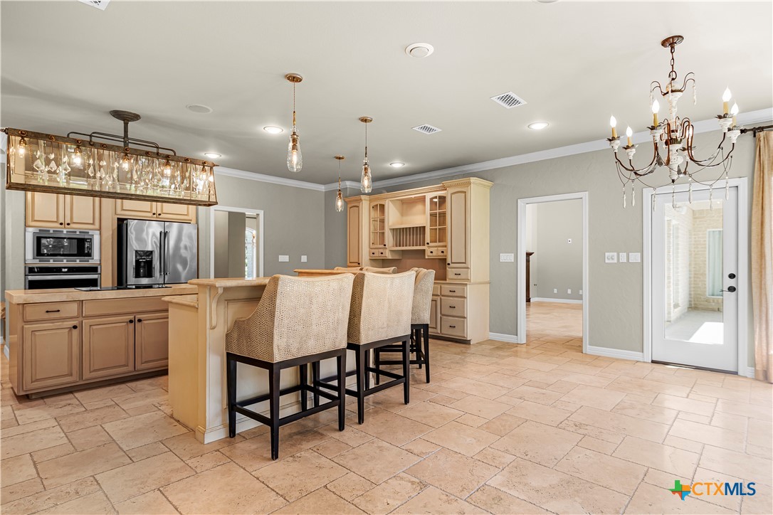 313 Treasure Oaks Road Inez, TX 77968 - Photo 10 of 47 a large kitchen with granite countertop a table and chairs