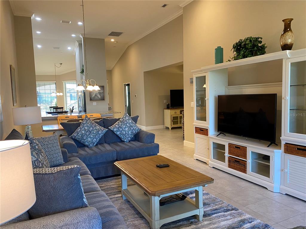 13711 Messina Loop, Unit 203 Lakewood Ranch, FL 34211 - Photo 12 of 27 a living room with furniture and a flat screen tv