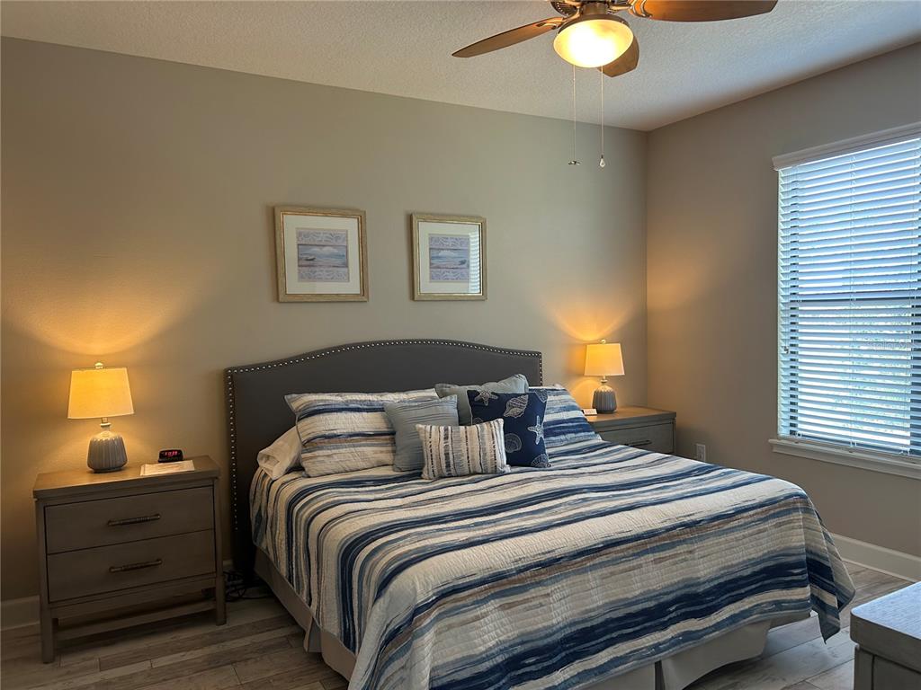 13711 Messina Loop, Unit 203 Lakewood Ranch, FL 34211 - Photo 15 of 27 a bedroom with a bed and a lamp