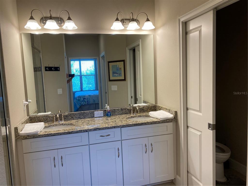13711 Messina Loop, Unit 203 Lakewood Ranch, FL 34211 - Photo 18 of 27 a bathroom with a sink and a mirror