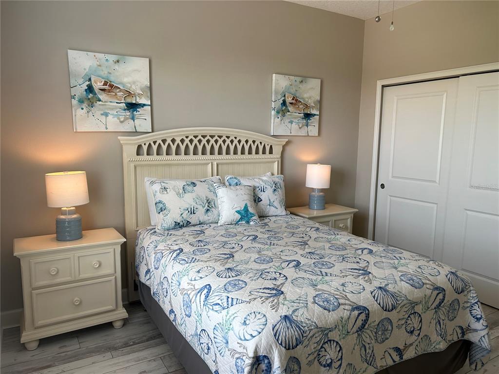 13711 Messina Loop, Unit 203 Lakewood Ranch, FL 34211 - Photo 22 of 27 a bedroom with a bed and a lamp on dresser