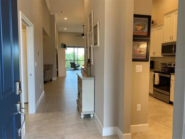 a view of a hallway with dining area and living room