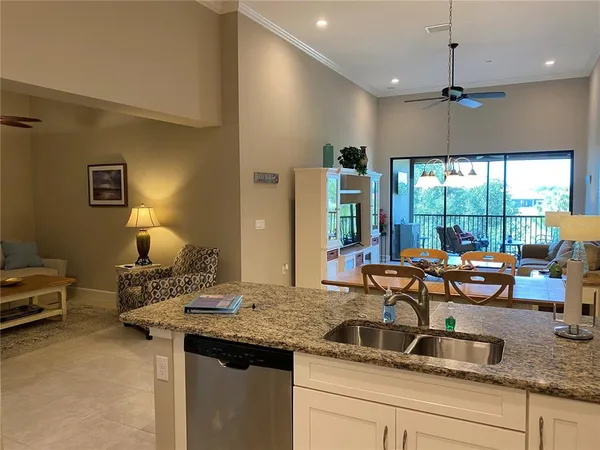 a kitchen with a sink and living room view