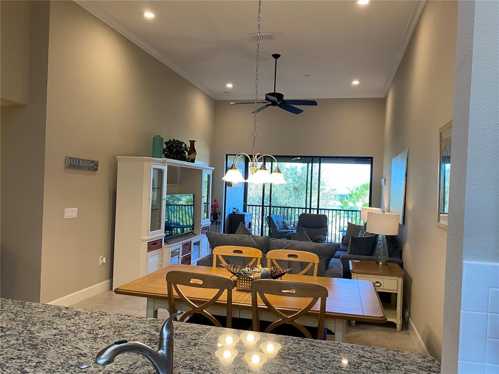 13711 Messina Loop, Unit 203 Lakewood Ranch, FL 34211 - Photo 7 of 27 a living room with furniture and a large window