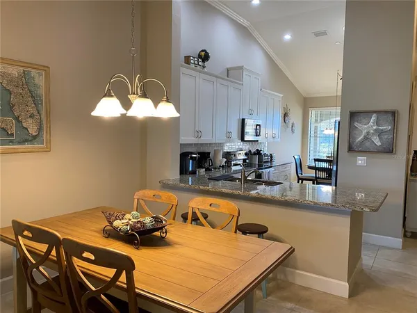 a kitchen with a table chairs and microwave