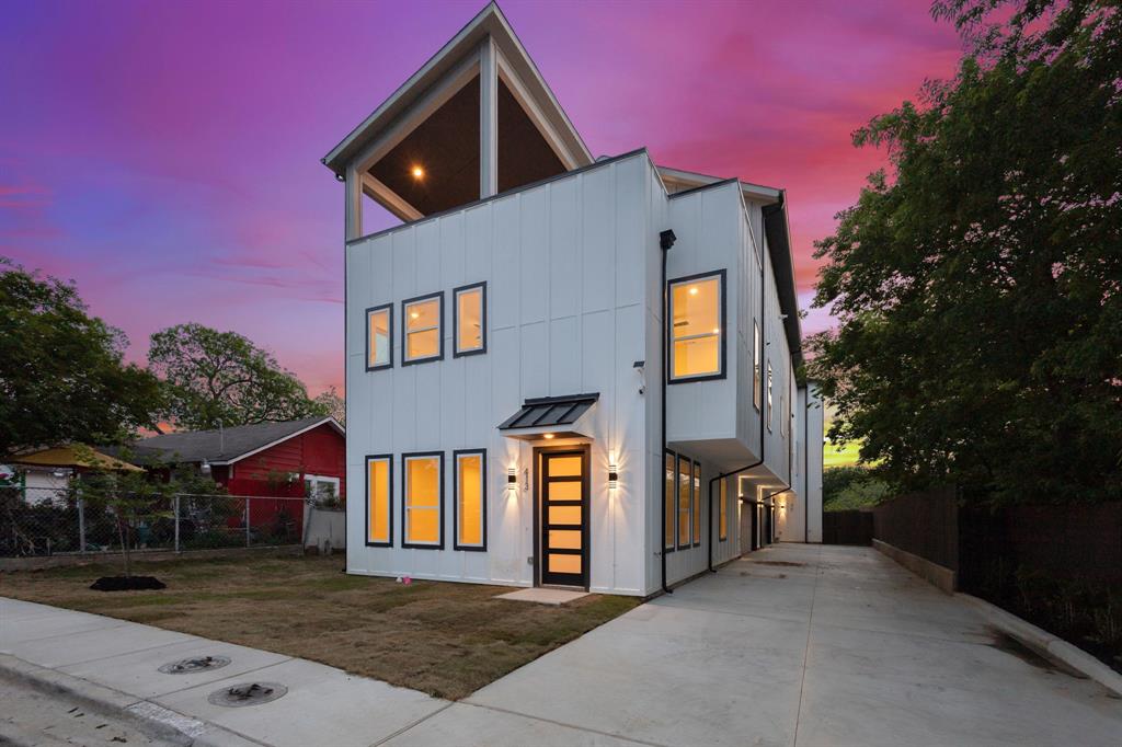 415 North Patton Avenue Dallas, TX 75203 - Photo 2 of 20 The property features a modern architectural style with white vertical siding and black-framed windows