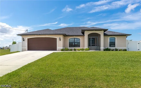 a front view of house with yard and green space