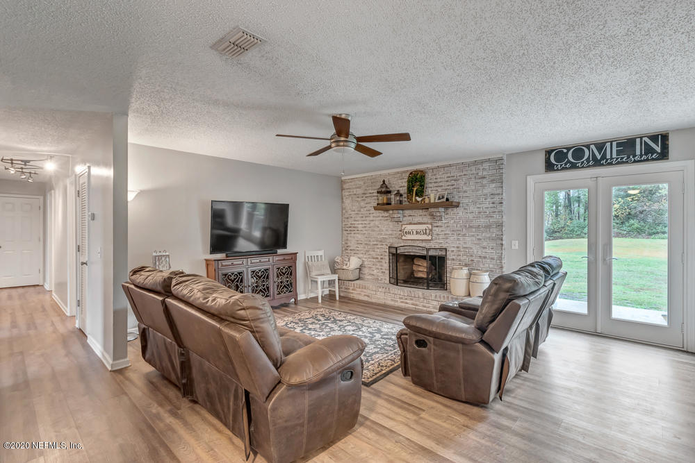 54071 Armstrong Road Callahan, FL 32011 - Photo 12 of 26 a living room with furniture fireplace and flat screen tv