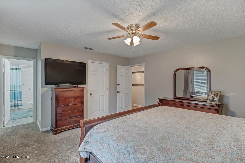 54071 Armstrong Road Callahan, FL 32011 - Photo 13 of 26 a bedroom with a bed and a flat screen tv