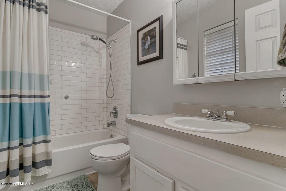 54071 Armstrong Road Callahan, FL 32011 - Photo 16 of 26 a bathroom with a sink a toilet and shower