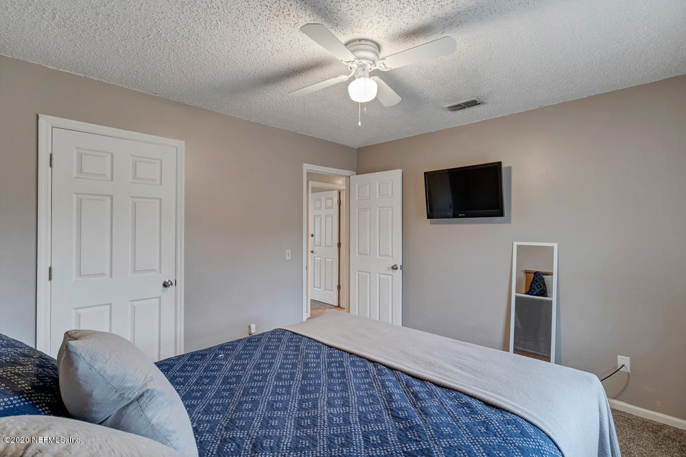 54071 Armstrong Road Callahan, FL 32011 - Photo 18 of 26 a bedroom with a bed and a flat screen tv