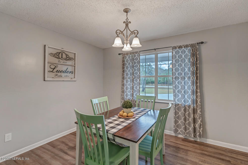 54071 Armstrong Road Callahan, FL 32011 - Photo 8 of 26 a dining room with furniture a chandelier and wooden floor