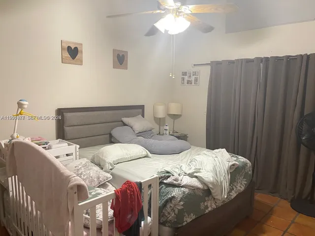 a bedroom with two beds and a chandelier