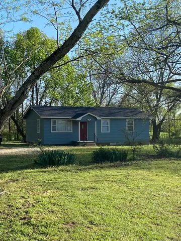 a backyard of a house with lots of green space