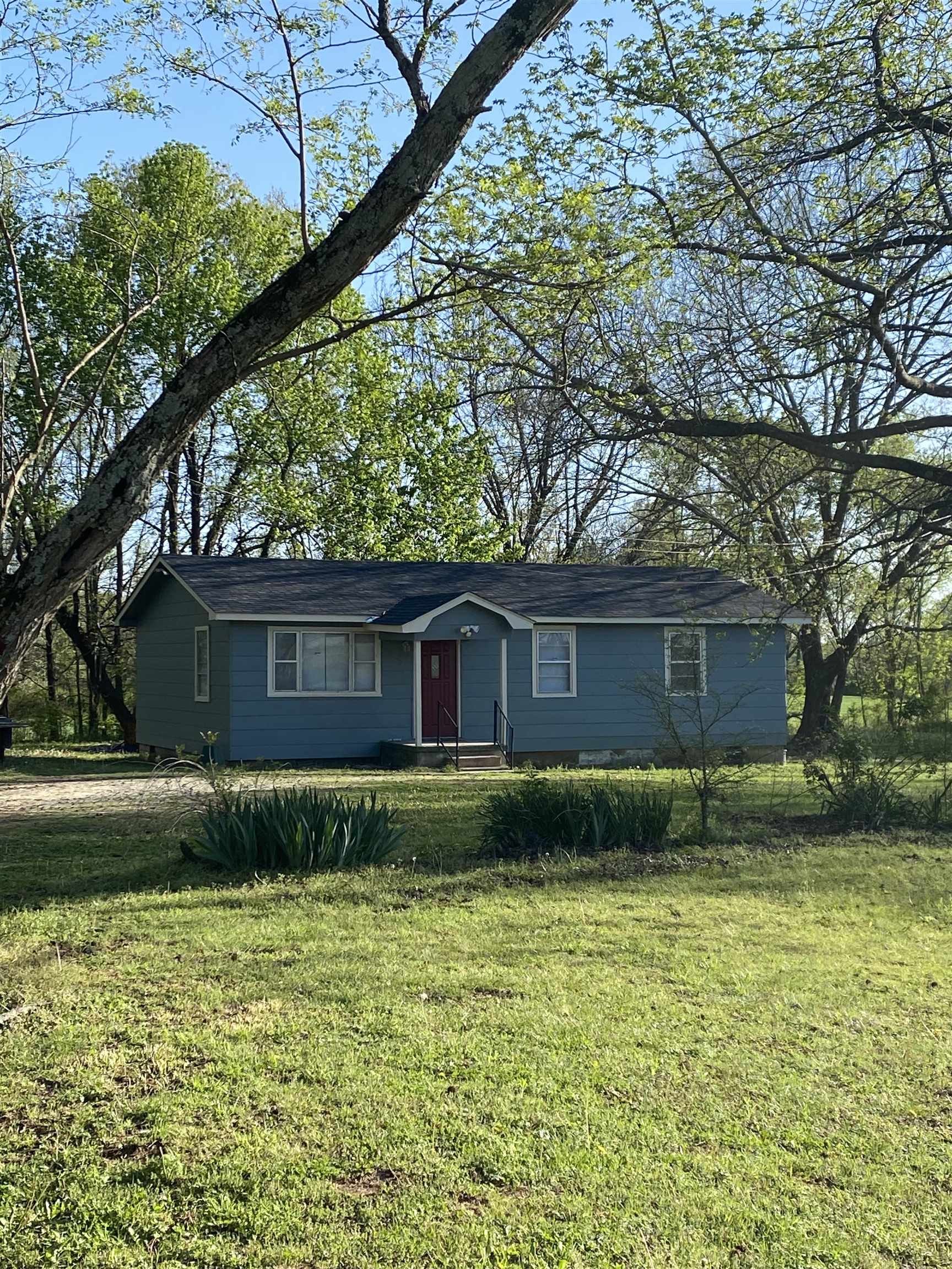 a backyard of a house with lots of green space