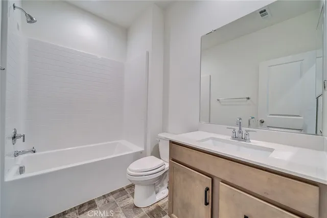 a bathroom with a sink a toilet and bathtub