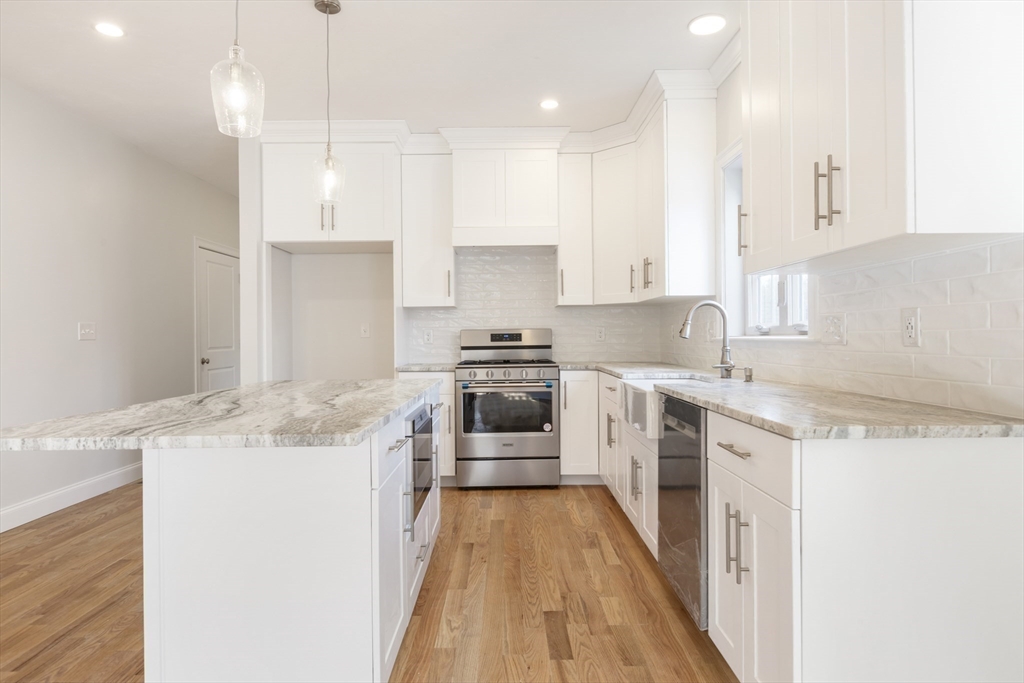 Lot 30 May Road Millis, MA 02054 - Photo 11 of 31 a kitchen with a stove a sink a microwave a counter top space and cabinets