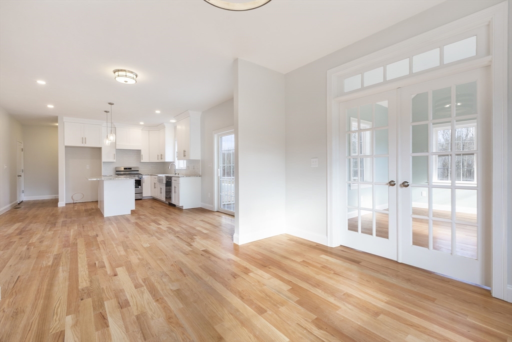 Lot 30 May Road Millis, MA 02054 - Photo 5 of 31 a view of a kitchen with kitchen island a sink wooden floor and a counter top space