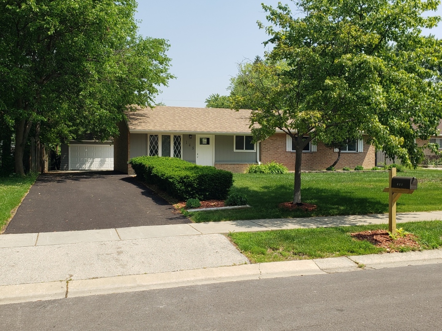 148 Delmar Drive Bolingbrook, IL 60440 - Photo 1 of 1 a front view of a house with a yard and potted plants