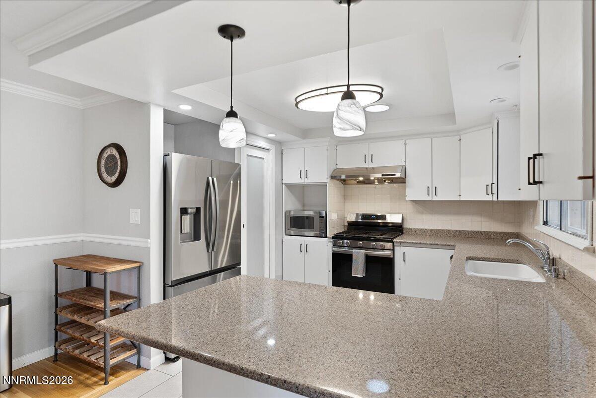 2205 Carlin Street Reno, NV 89503 - Photo 13 of 51 a kitchen with a center island and stainless steel appliances