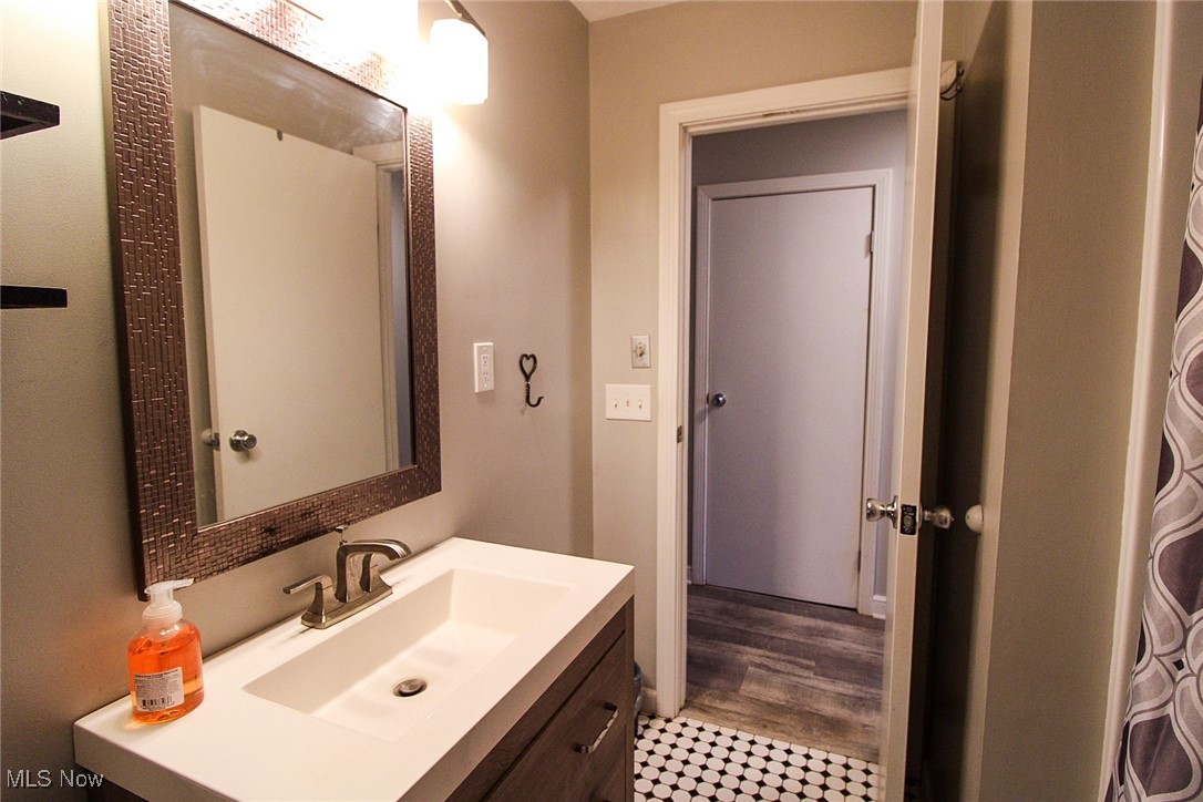3267 South Leavitt Road Southwest Warren, OH 44481 - Photo 23 of 45 Bathroom with vanity and a shower with shower curtain