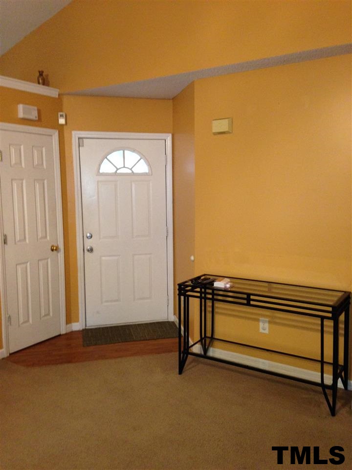 1905 Maybrook Drive Raleigh, NC 27610 - Photo 3 of 17 Open & spacious foyer with plant shelving & a convenient coat closet.